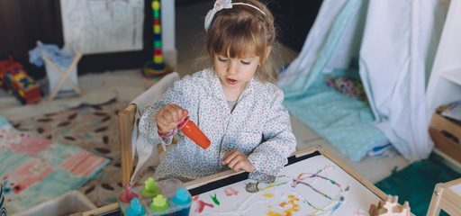 Toddler painting from her own imagination 